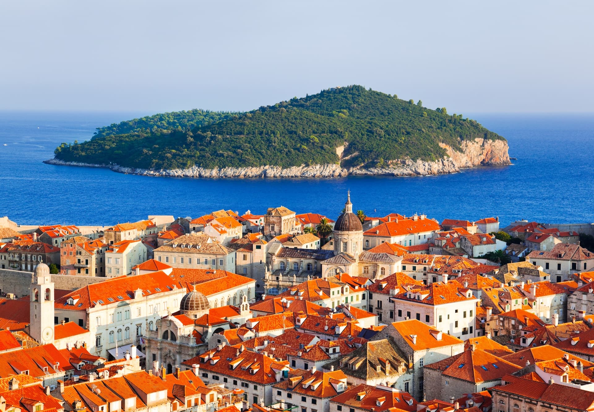 Rooftops of Lopud town with Lokrum Island in the blue Adriatic Sea