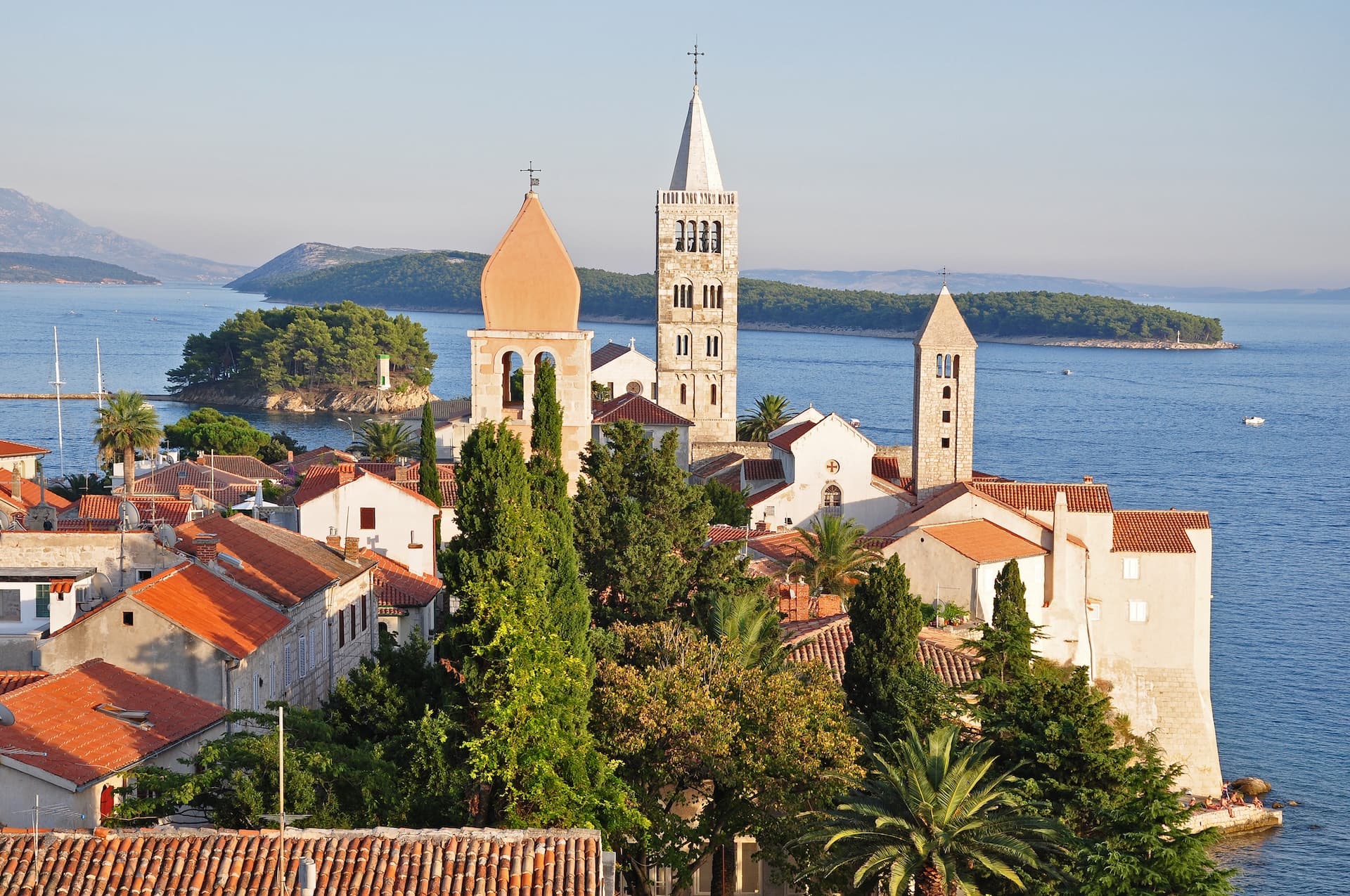 Bell towers and terracotta roofs overlooking the sea in Mljet National Park, Croatia.